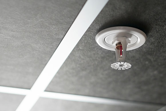Close up of a fire sprinkler in a ceiling
