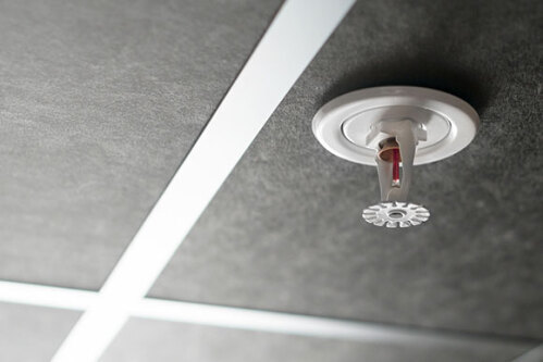 Close up of a fire sprinkler in a ceiling
